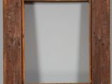 a close up of a wooden picture frame on a table