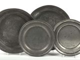 three silver plates are stacked on top of each other on a white surface
