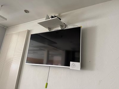 a flat screen tv mounted on the wall in the corner of a room