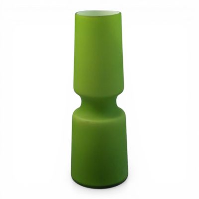 the small green vase is sitting on a white surface