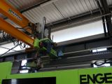 a crane that is working on a machine in a building