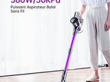 the woman is using the vacuum to clean the wood floor