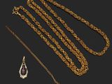 a collection of gold jewellery including a necklace and a pendant