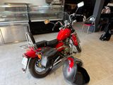 a red motorcycle that is parked in front of a counter