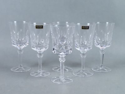 six wine glasses are lined up in a row on a table