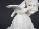a statue of a child with a bird on his shoulder