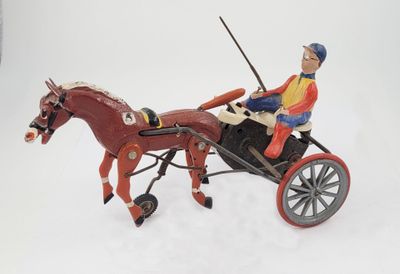 a figurine of a man riding in a horse drawn carriage