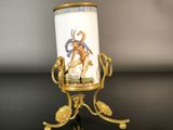 a vase with a picture of a man on it on a stand
