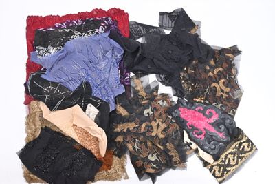 a pile of assorted clothing on a white surface