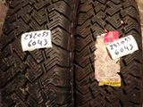 two tires with stickers on them sitting next to each other