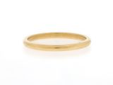 a close up of a gold ring on a white background