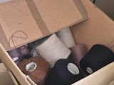 a cardboard box filled with assorted items in a room