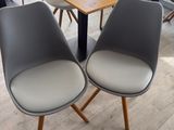 two chairs sitting at a table in the middle of a room