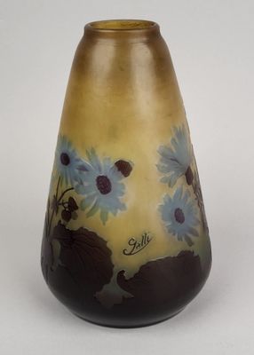 a vase with flowers painted on it sitting on a table