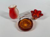 a small glass vase and a small glass vase on a white surface