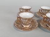 three cups and saucers sitting on a table