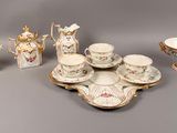 many pieces of porcelain on display on the table