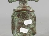 a small green vase with a cross on it