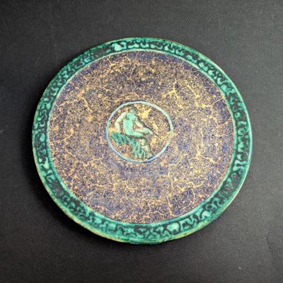 a green plate with a picture of a man on it