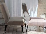 two chairs sitting next to each other on a tiled floor