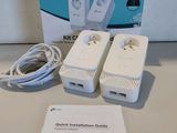 a box of power cords and a charger on a table