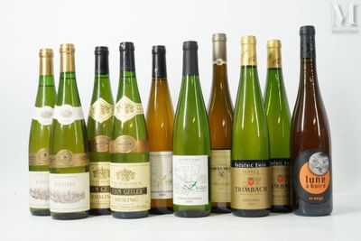 several bottles of wine are lined up in a row on a white surface