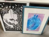 two framed pictures of a horse and a horse on the table