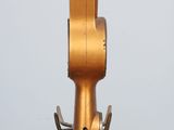 a gold metal object on a wooden table