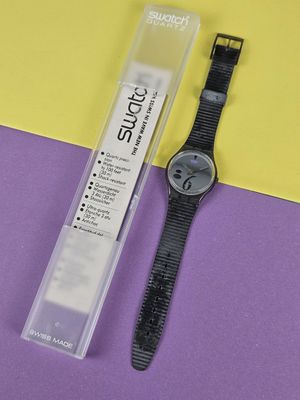 a watch that is sitting next to a plastic box