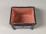 a small black box with a pink interior sitting on a table