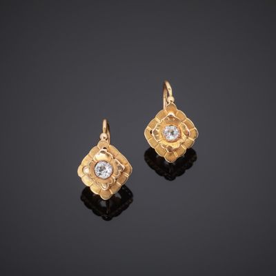 a pair of gold and diamond earrings