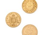 three different types of gold coins on a white surface
