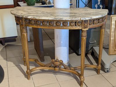 a marble topped table with a vase on top of it
