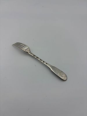 a fork and a spoon on a white surface