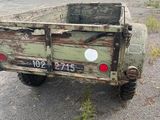 a old truck that is parked in the parking lot