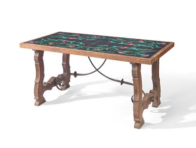 the table is made of wood and has a black and green tile top