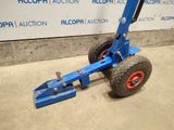 an image of a blue hand truck with red wheels