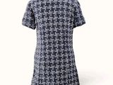 the back of a woman ' s dress with a blue and white checkered pattern