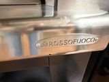 a close up of a stainless steel oven with a sign on it