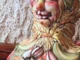 a ceramic figurine of a woman sitting on a table
