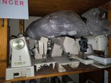 many sewing machines sitting on a shelf in a room