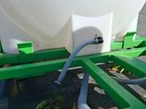 a large white tank sitting on top of a green cart