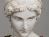 marble bust of a woman in a red dress with a turban on her head