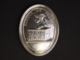 a picture of a silver coin with a picture of a woman on it
