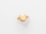 a gold signet ring with an oval design