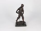 a bronze statue of a man with a dog on a leash