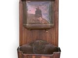 a wooden wall mounted shelf with a picture on it
