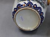 a close up of a vase with a bird on it