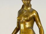bronze statue of a woman holding a tennis racquet on a marble base