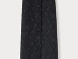 a woman is wearing a black skirt with a black floral pattern